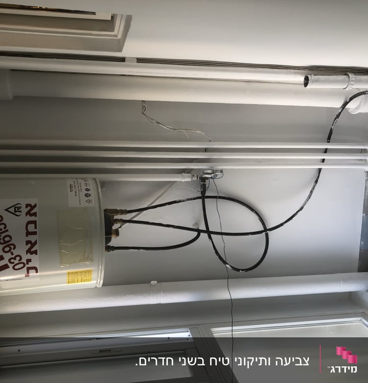 צינורות צבועים בלבן על קיר לבן